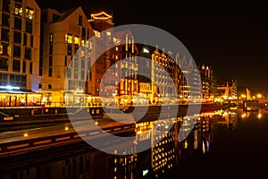 Old town in Gdansk at night. The riverside on Granary Island reflection in Moltawa River Cityscape at twilight. Ancient