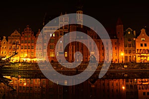 Old town in Gdansk at night. The riverside on Granary Island reflection in Moltawa River Cityscape at twilight. Ancient