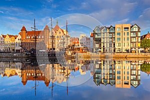 Old town of Gdansk reflected in the Motlawa river at sunrise, Poland.