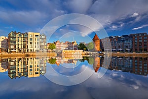 Old town of Gdansk reflected in the Motlawa river at sunrise, Poland.