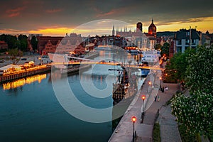 Old town of Gdansk reflected in the Motlawa river at sunset, Poland