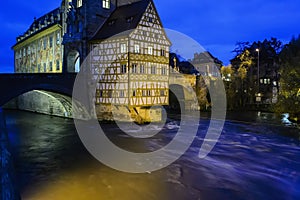 Old town hall or Altes Rathaus with two bridges over the Regnitz river at night in Bamberg, Bavaria, Franconia, Germany