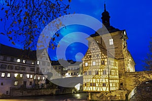 Old town hall or Altes Rathaus with two bridges over the Regnitz river at night in Bamberg, Bavaria, Franconia, Germany