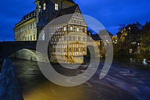 Old town hall or Altes Rathaus with two bridges over the Regnitz river at night in Bamberg, Bavaria, Franconia, Germany