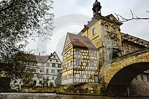 Old town hall or Altes Rathaus with two bridges over the Regnitz river at night in Bamberg, Bavaria, Franconia, Germany