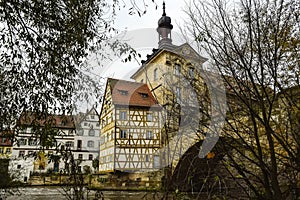 Old town hall or Altes Rathaus with two bridges over the Regnitz river at night in Bamberg, Bavaria, Franconia, Germany