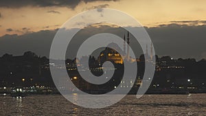 Old town Istanbul in prayer time. Looking over Golden Horn to Suleymaniye Mosque on a twilight sky. 4K UHD video, 3840