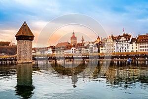 Old town of Lucerne, Switzerland at sunset in winter. Famous wooden Chapel Bridge on Reuss river and Lucerne lake. Swiss