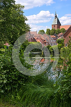 Old town of the medieval small city Moelln with typical red brick buildings and St. Nikolai church seen from the park in Schleswig