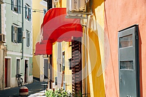 Old town narrow alley with colorful buildings in Piran, Slovenia