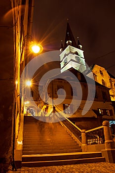 Old town narrow passage with stairs and a clock tower