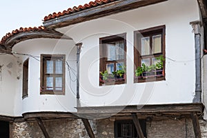 Old Town of Nesebar. Authentic cute facade of a Bulgarian house. ground floor made of stone
