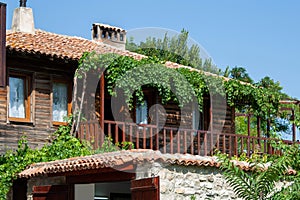 Old Town of Nesebar. Authentic wooden facade of a Bulgarian house. Decorated with vines that winds