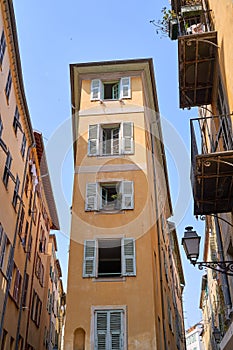 Old Town of Nice city in France, narrow apartment building with shuttered windows n historical district Vieille Ville