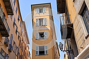 Old Town of Nice city in France, narrow apartment building with shuttered windows n historical district Vieille Ville