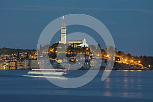 Old town of Rovinj with sea by night