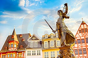 Old town square Romerberg with Justitia statue in Frankfurt Main, Germany with blue sky