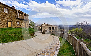 Old town street with curved street and wooden fence next to the garden. La Hiruela Madrid