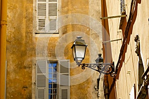 Old town street lamp placed on the facade building