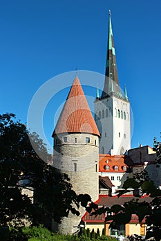 Old town of Tallinn, Estonia with bell tower of Saint Olaf church against blue sky