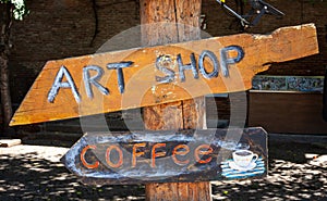 Old Town, Tbilisi - Georgia - 06.25.2023: Hand Made Direction Sign Written Art Shop and Coffee on Shaped Wooden Arrow
