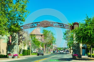 Old Town Temecula gateway arch depict themes from western history and welcomes visitors to tourist destination in Temecula Valley