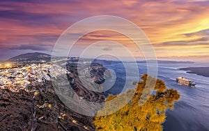 Old Town Thira on the Santorini island, famous churches against colorful sunset in Greece photo