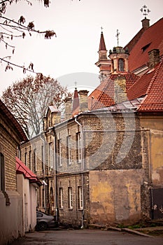 Old town Vilnius street with yellow brick wall building