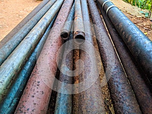 Old, toxic, rusty lead pipes on construction site