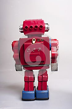 Old toy from the 1950s of a lonely and paradi robot made of red tin battery operated