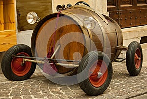 Old toy car with barrel and red wheels