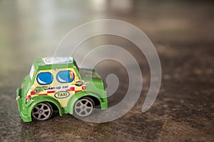Old toy car on the concrete floor