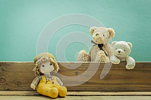 Old toy and Teddy bear on old wood in front green background .