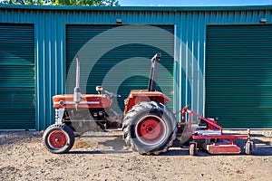 Old tractor with attached lawn mower.