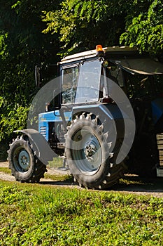 Old tractor with a device for harvesting apples. Boxes for harvesting