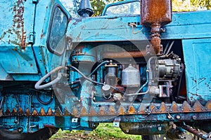 Old tractor engine in oil stains and rust background