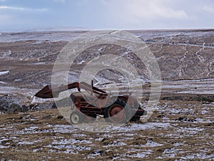An old tractor with front loader on a meadow