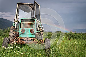 Old tractor on the grass field