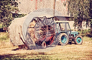 Old tractor with hay, yellow filter