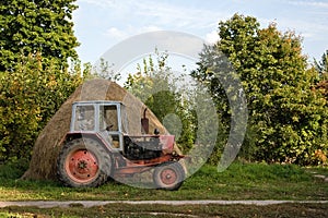 Old tractor and haystack