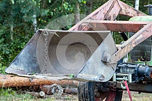 Old tractor loader. Front view of rusty loader