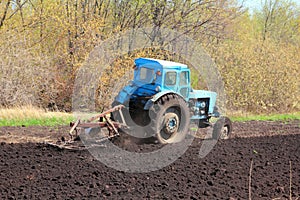 Old tractor with plough