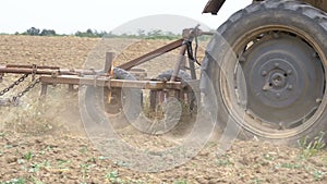 Old tractor plowing field. Slow Motion