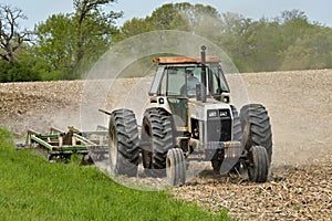 old tractor pulling a cultivator