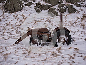 An old tractor on a snowy meadow