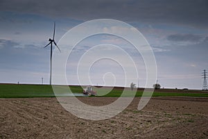 old tractor spraying pesticides