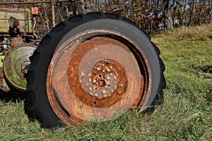 Old tractor tire and wheel full of rust