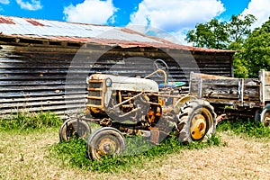 Old tractor by wood barn