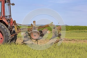 Old tractor working on the field