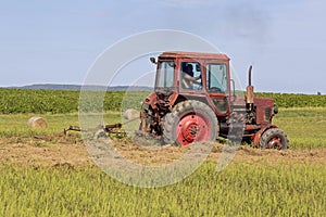 Old tractor working on the field